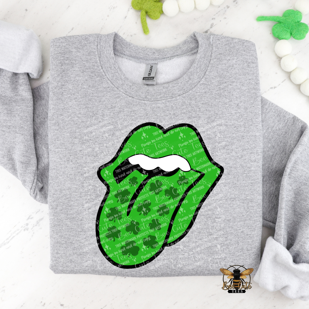 Gray sweatshirt with green lips graphic featuring shamrocks on a white background