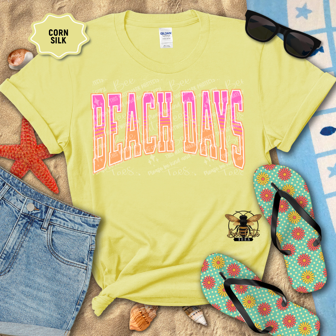 Yellow t-shirt with 'Beach Days' text on a sandy background with flip-flops and sunglasses.