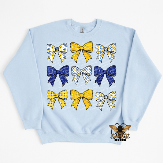 Light blue sweatshirt with colorful bow designs on a white background