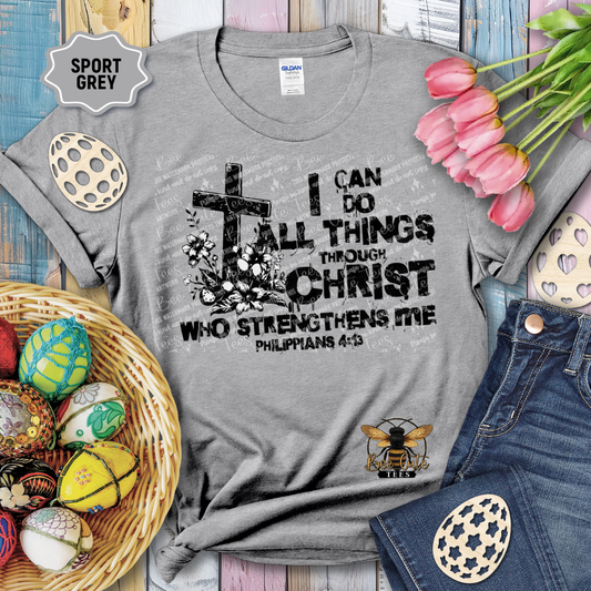 Gray t-shirt with motivational quote, surrounded by Easter decorations on a wooden surface.