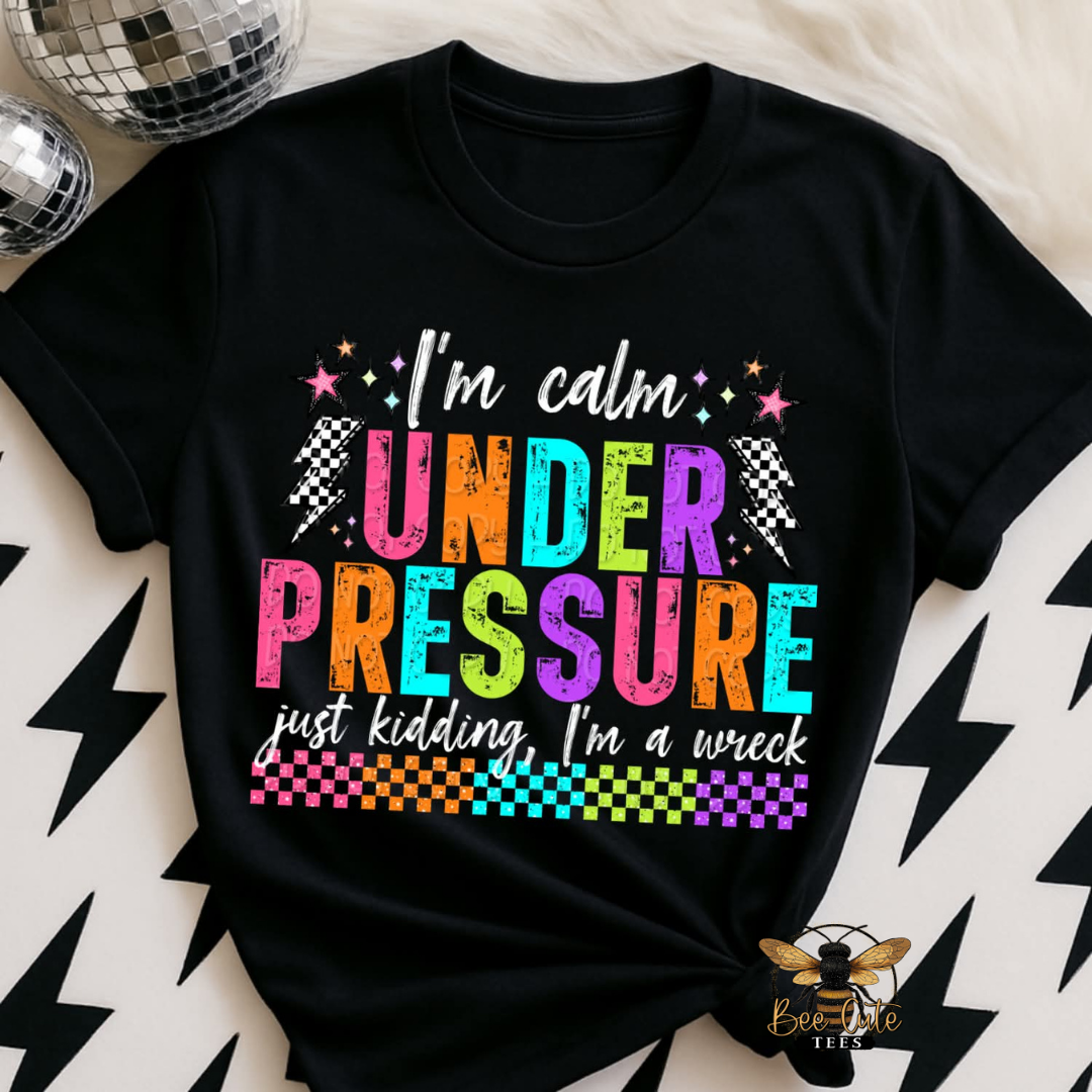 Black t-shirt with colorful text design on a patterned surface