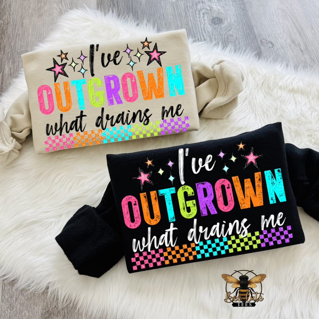 Two sweatshirts with colorful text on a fluffy white surface
