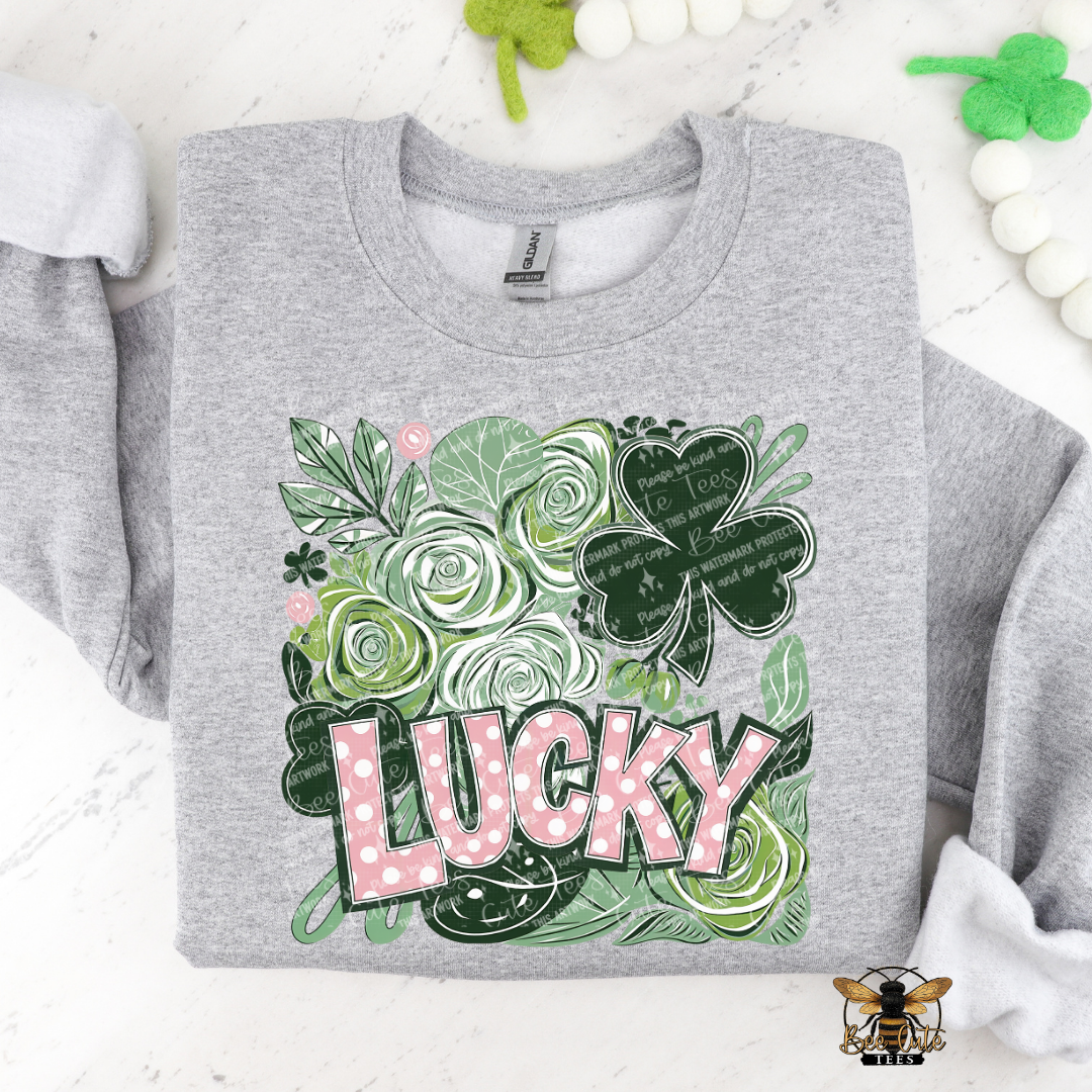 Gray sweatshirt with 'Lucky' design featuring shamrocks and roses on a white background.