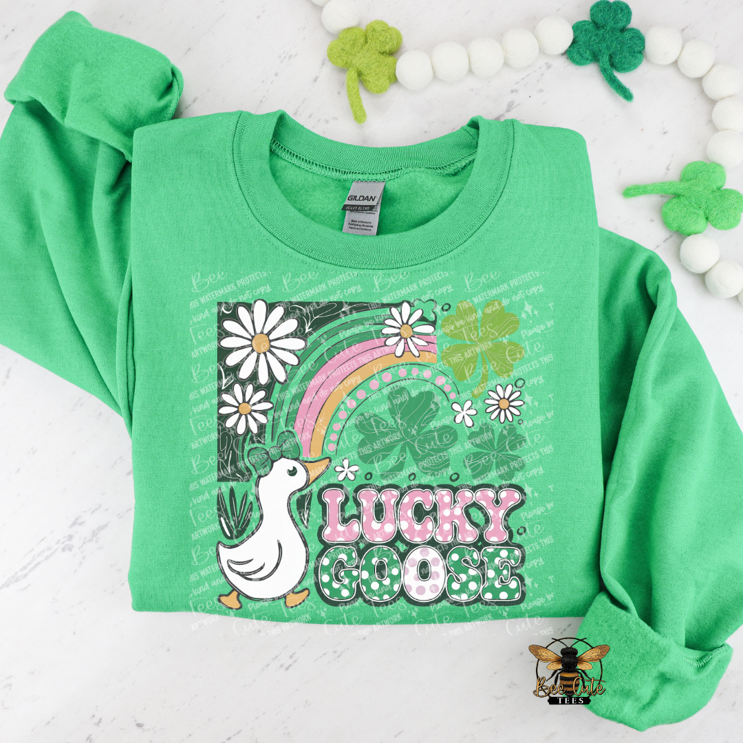 Green sweatshirt with 'Lucky Goose' design on a white background with decorative elements.