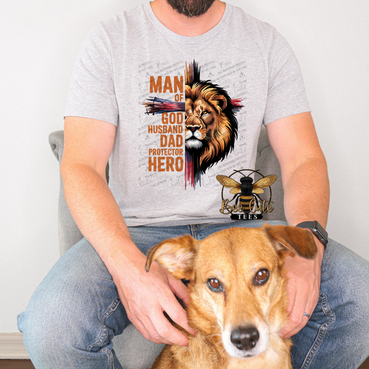 Person wearing a t-shirt with a lion graphic and text, sitting with a dog.