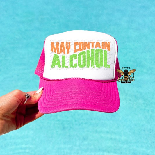 Pink and white cap with 'May Contain Alcohol' text on a blue background