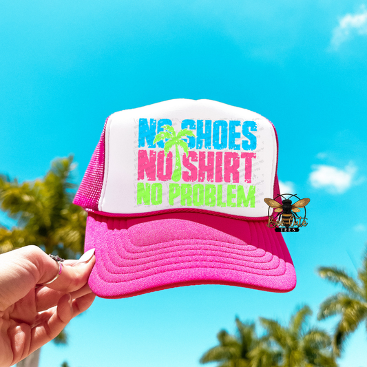 Pink and white cap with 'No Shoes, No Shirt, No Problem' text against a blue sky background