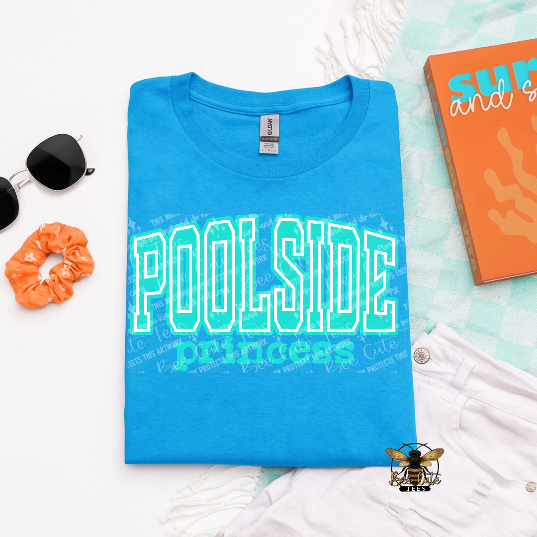 Blue t-shirt with 'POOLSIDE' text on a light blue background with accessories.