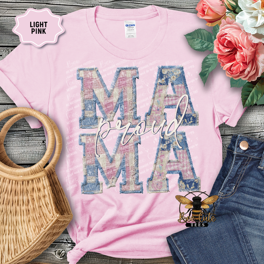 Light pink t-shirt with 'MAMA' print on a wooden surface with flowers and denim jeans.