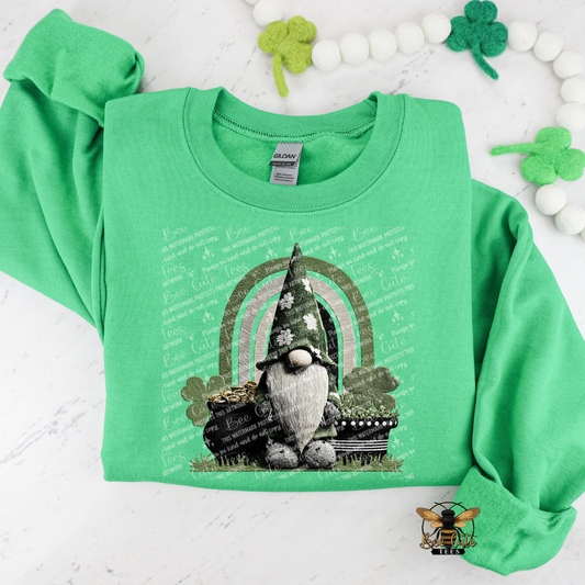 Green sweatshirt with a gnome and rainbow design on a white background with shamrocks.