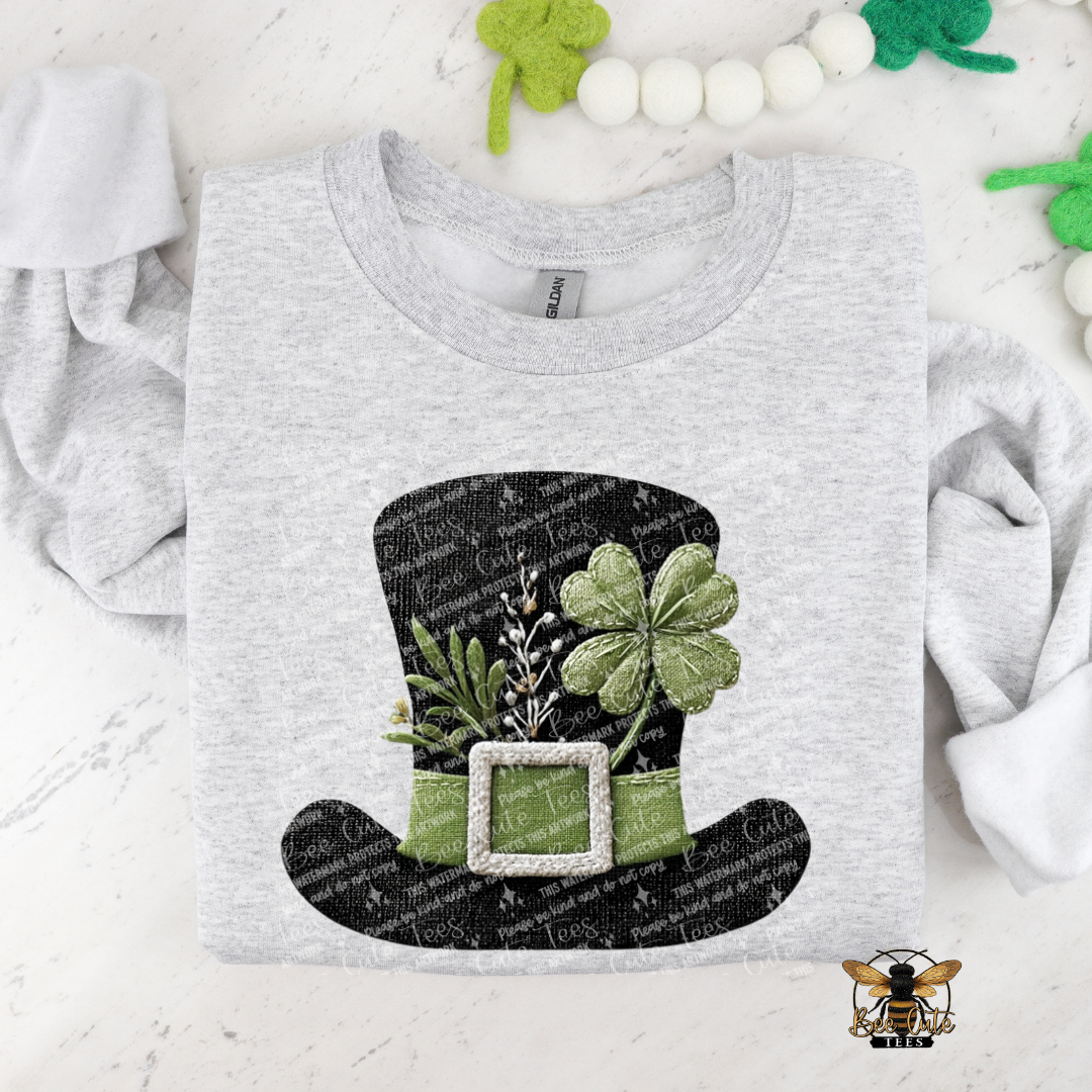 Gray t-shirt with a black leprechaun hat design featuring green shamrocks on a white background.