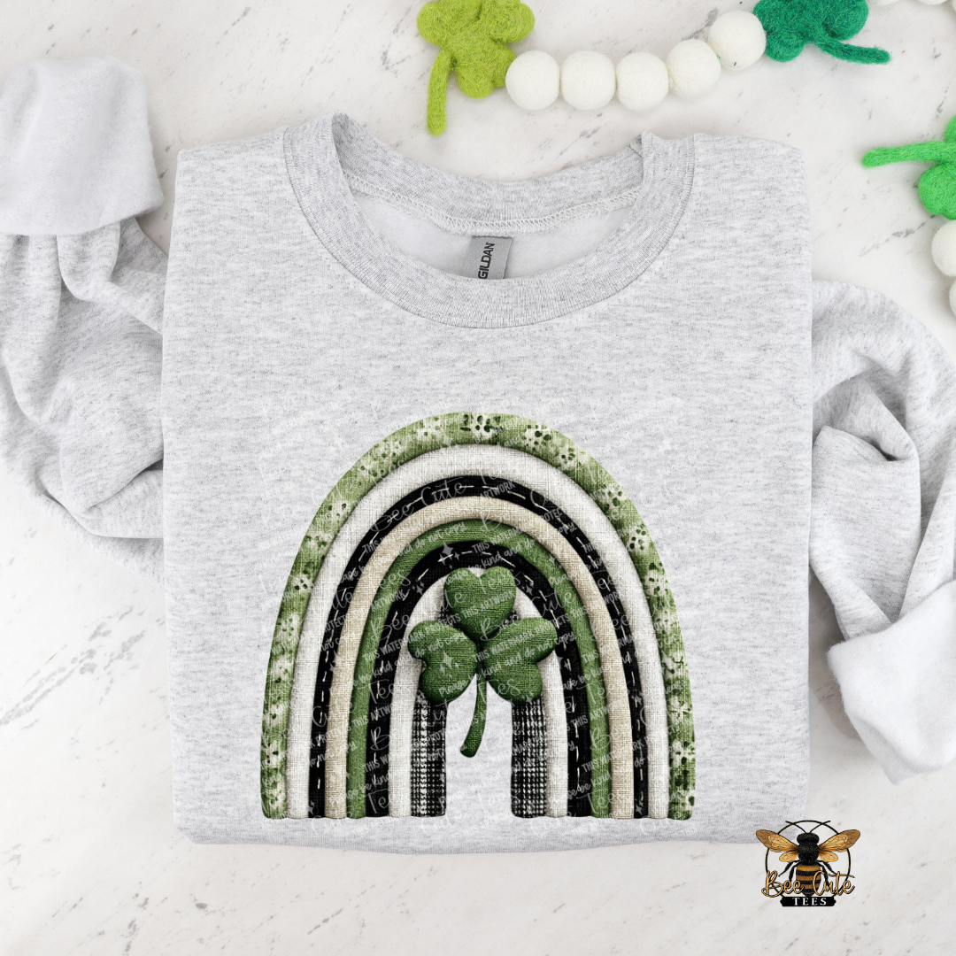 Gray t-shirt with a rainbow and shamrock design on a white background
