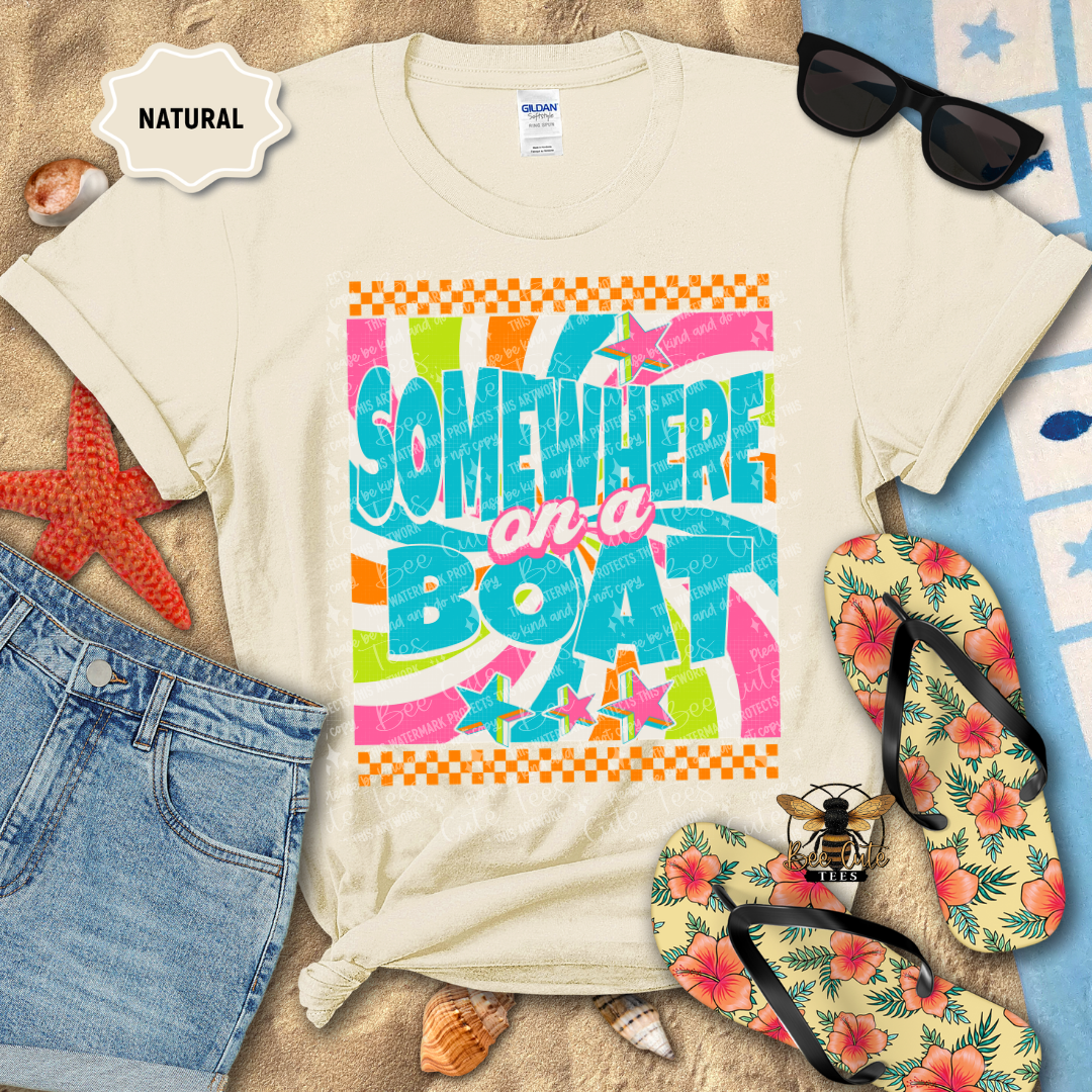 Beige t-shirt with 'Somewhere on a Boat' design, sunglasses, flip-flops, and beach items on a sandy background