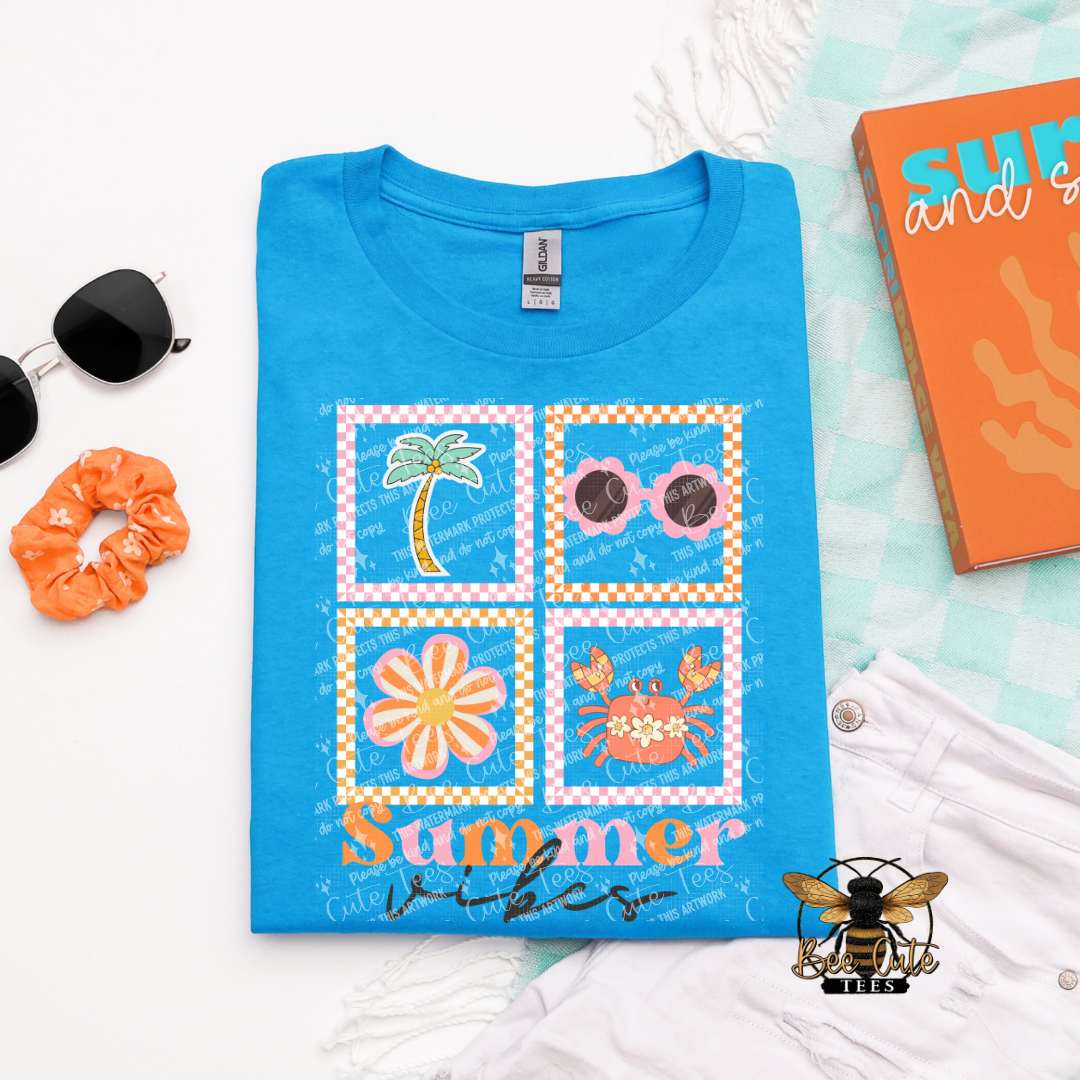Blue t-shirt with summer-themed design on a light blue background