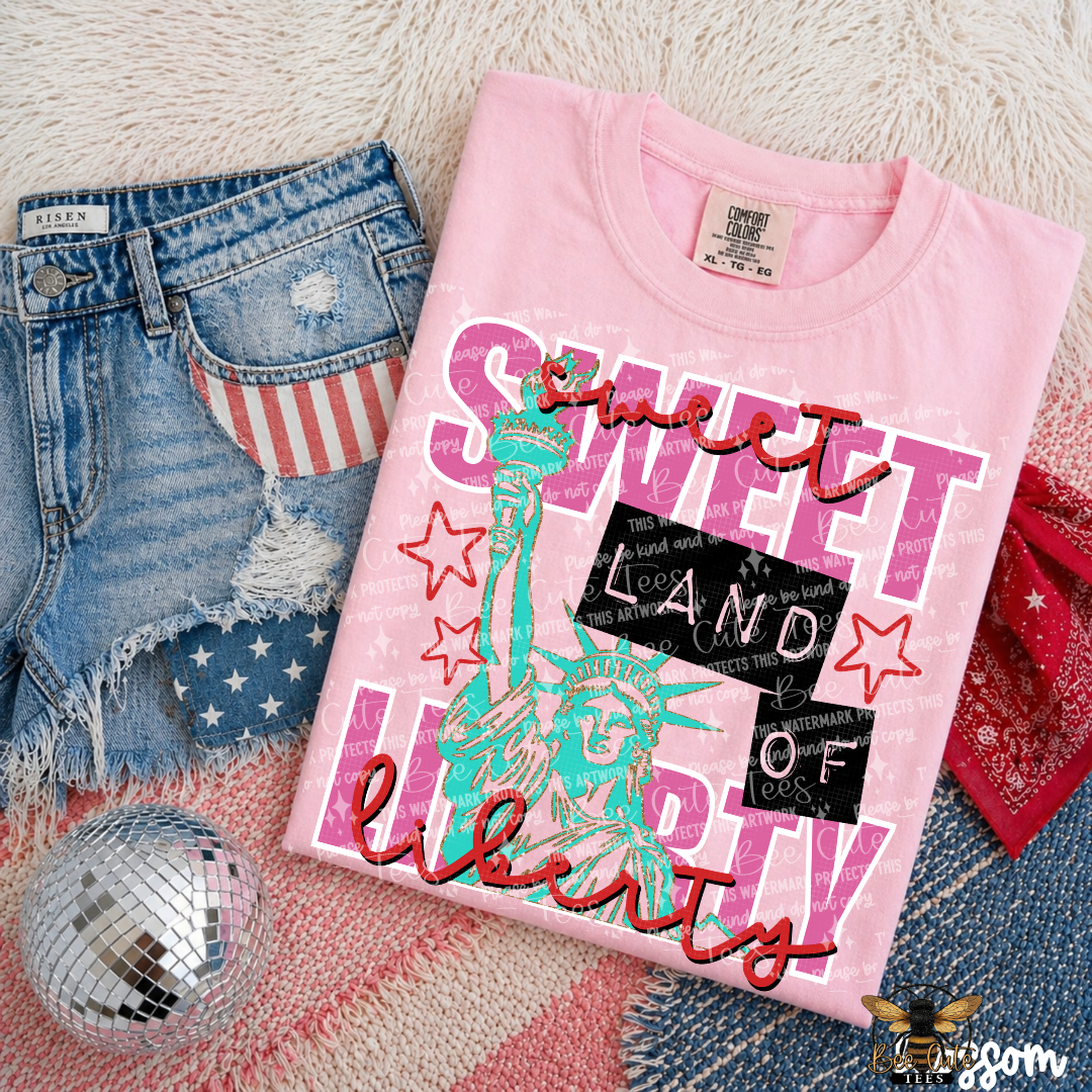 Pink t-shirt with 'Sweet Land of Liberty' design on denim shorts and a disco ball.