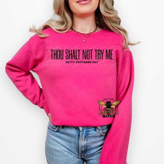 Person wearing a pink sweatshirt with text and a bee logo on a white background