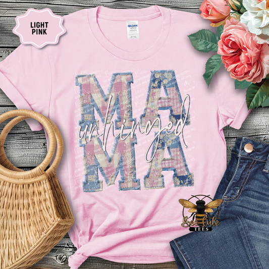 Light pink t-shirt with 'MAMA' print on a wooden surface with flowers and denim jeans.