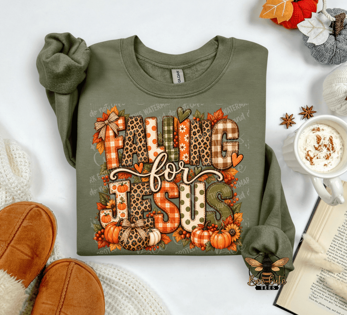 An olive green long-sleeve t-shirt with a 'FALLING FOR JESUS' autumn-themed graphic, styled in a cozy flat-lay arrangement with a mug of coffee, an open book, and brown slippers.