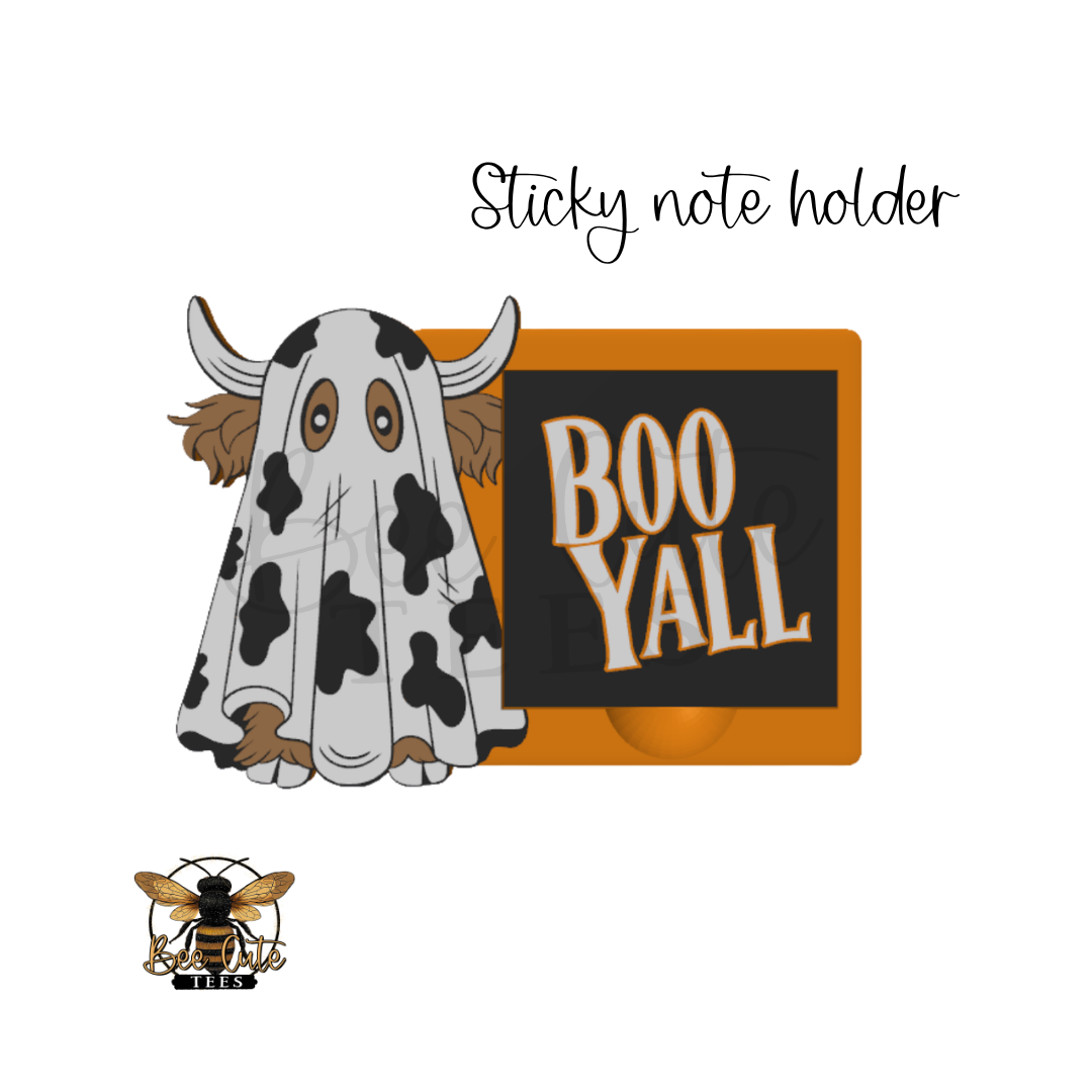 A cartoon-style sticky note holder design featuring a cow-print ghost and an orange-bordered black note pad with the words “BOO YALL” in white and orange. The text “Sticky note holder” appears above, and a bee logo with “Bee Cute Tees” appears at the bottom left on a white background.