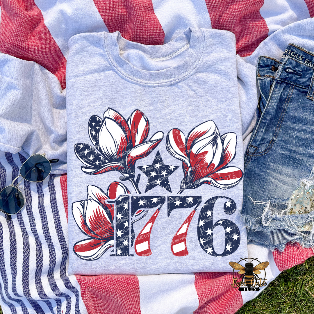 Folded gray sweatshirt with 1776 design on a flag background