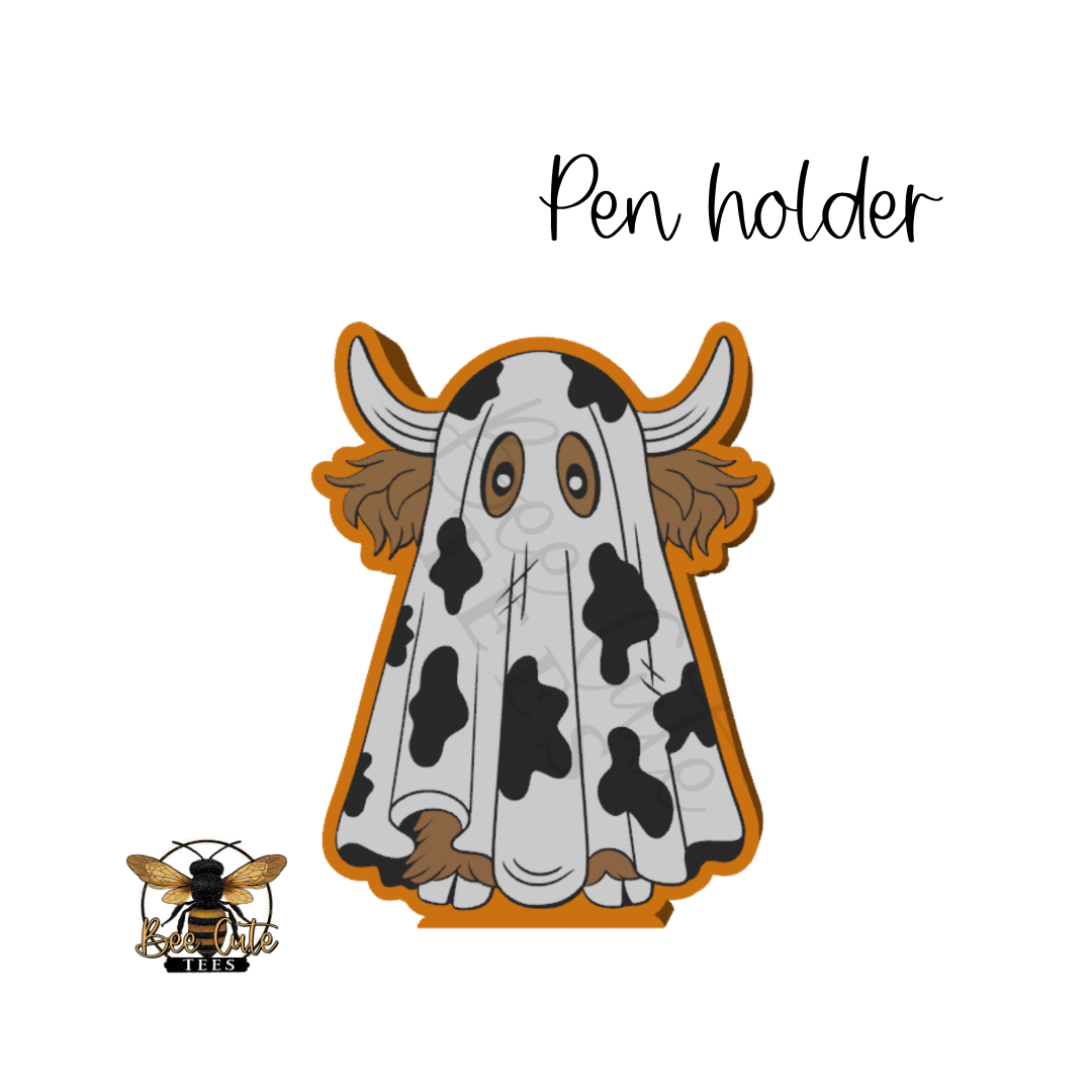 A ghostly cow-themed pen holder charm or badge on a plain white background, with the words 'Pen holder' above it and a small bee logo in the lower left corner.
