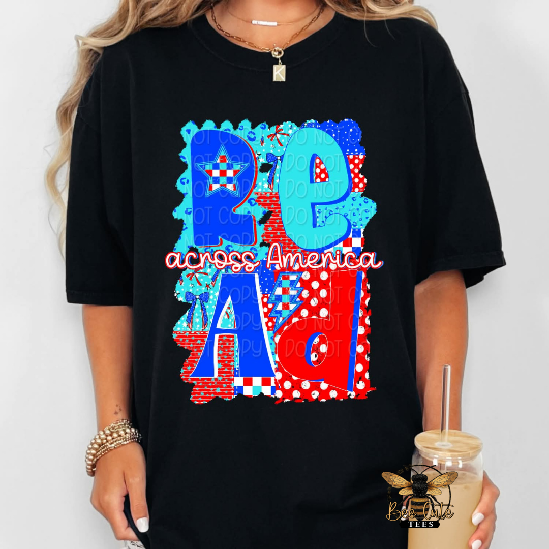 Black t-shirt with colorful text design held by a person.