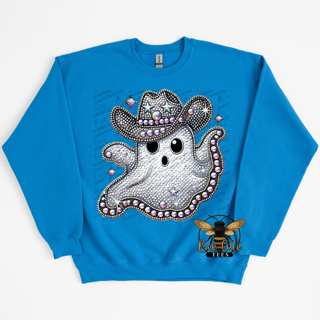 A bright blue crewneck sweatshirt featuring a rhinestone-embellished cartoon ghost wearing a cowboy hat, with a small bee logo near the lower right of the print.