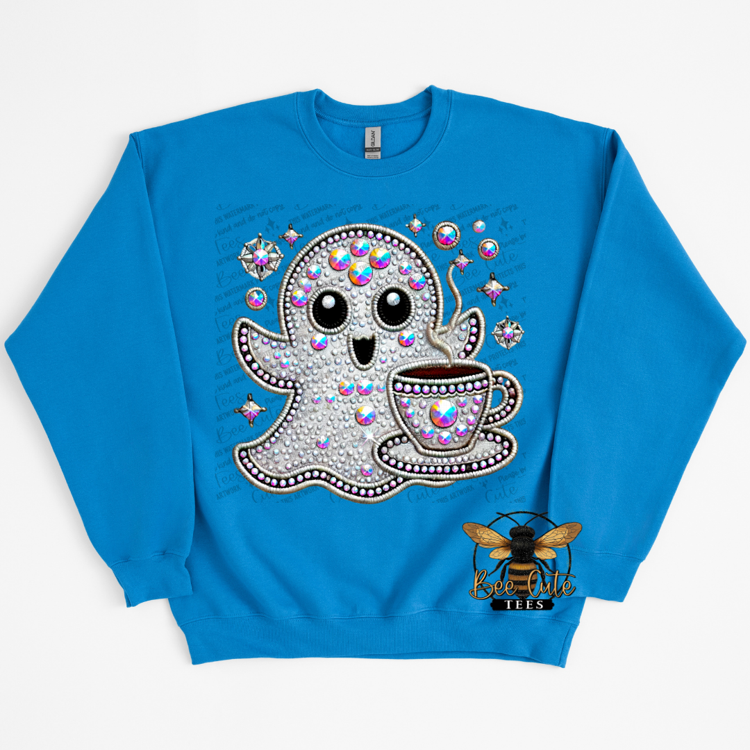 A bright blue crewneck sweatshirt featuring a rhinestone-embellished graphic of a cute ghost drinking coffee from a teacup, with a bee logo on the lower right front.