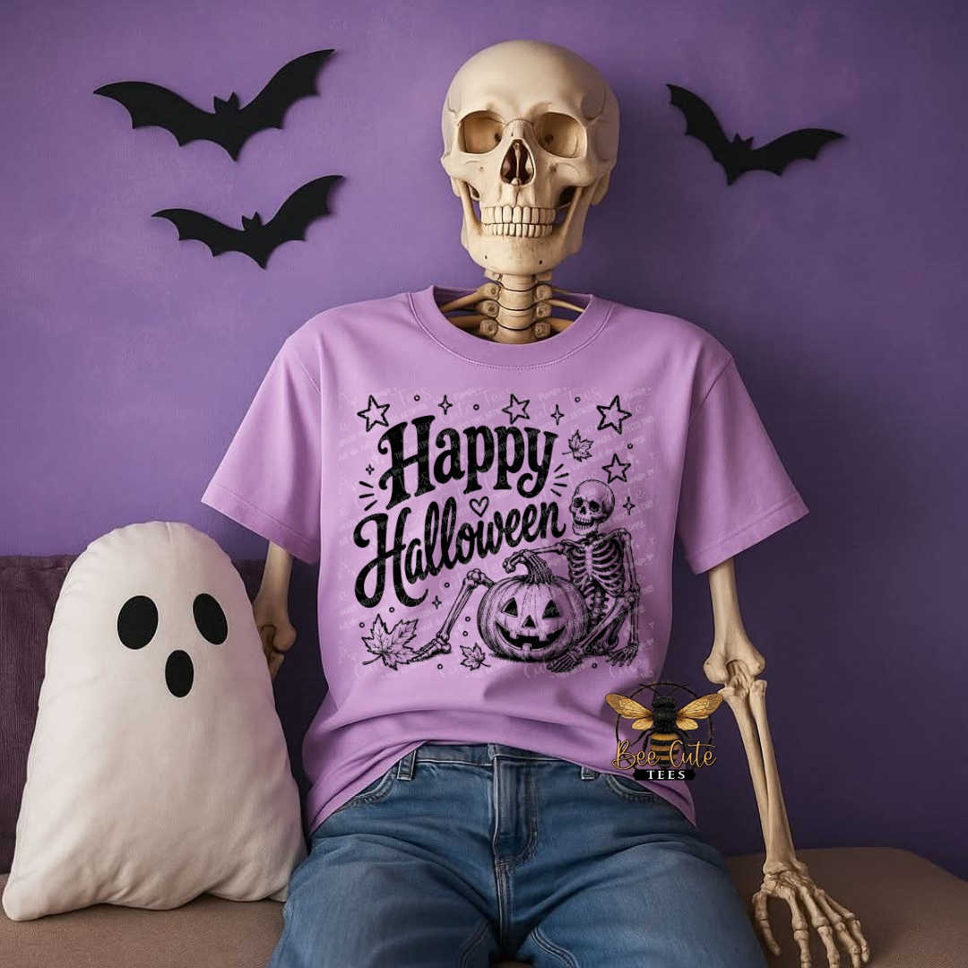A skeleton mannequin wearing a lavender purple graphic t-shirt that says 'Happy Halloween' with a jack-o'-lantern and bat design, posed against a purple wall with Halloween decorations including a ghost pillow and bat cutouts.