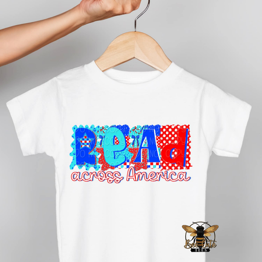 White t-shirt with colorful text on a hanger against a gray background