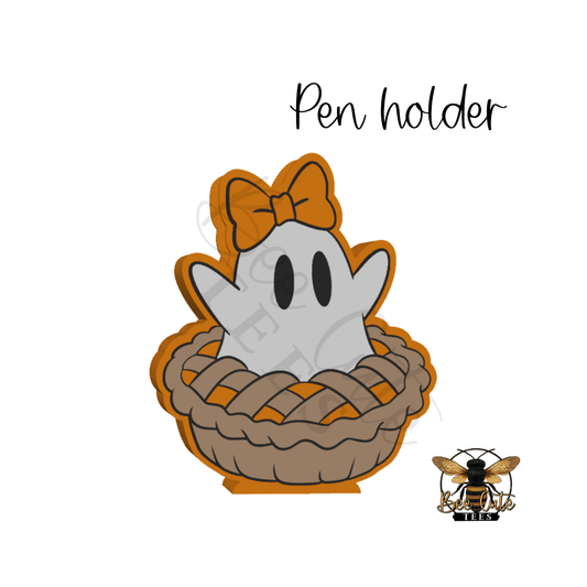 A cute ghost character peeking out of a pie crust basket, with the words 'Pen holder' above it and a small bee logo at bottom right on a white background.