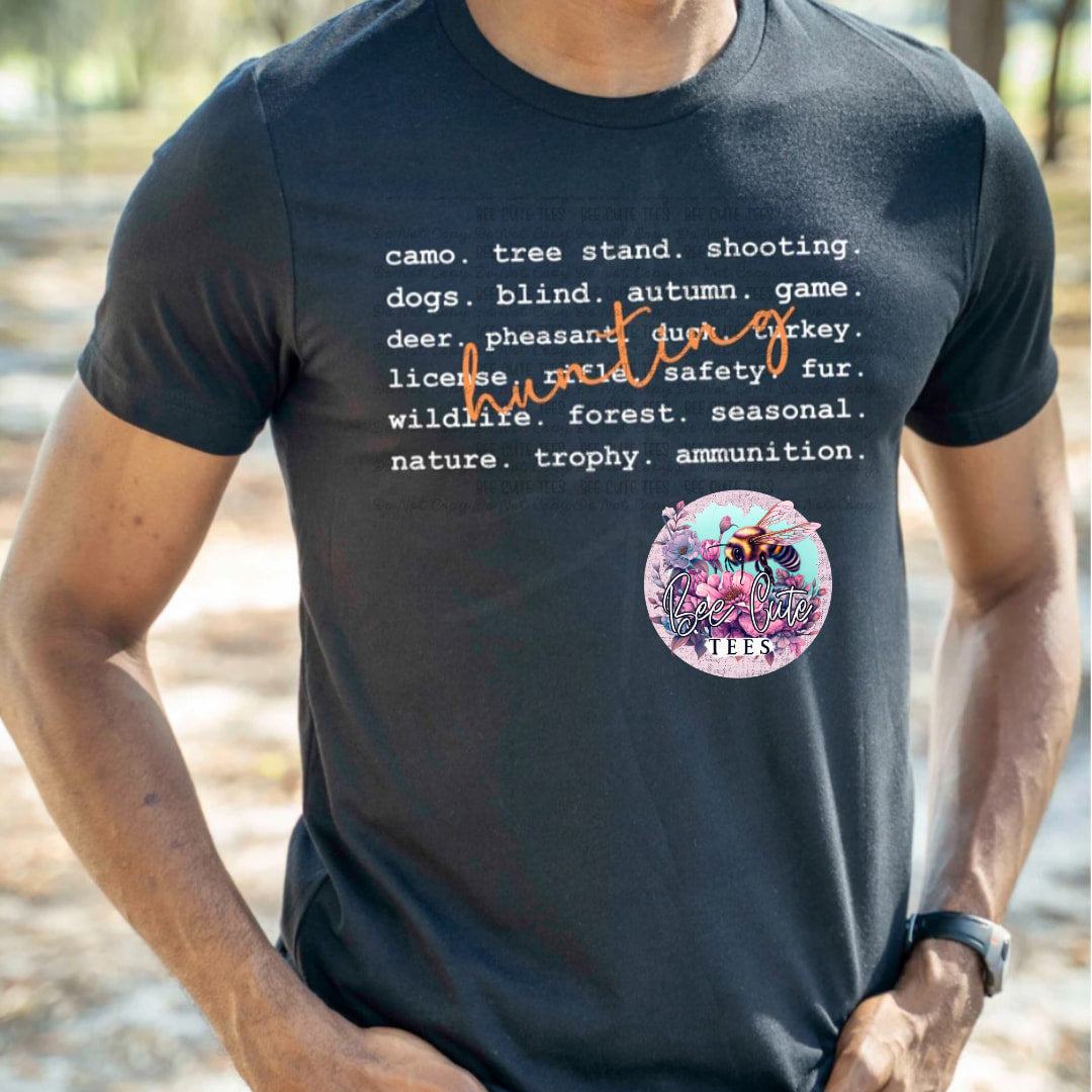 Person wearing a black t-shirt with text and a graphic design outdoors.