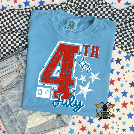 Blue t-shirt with '4th of July' design on a checkered fabric background