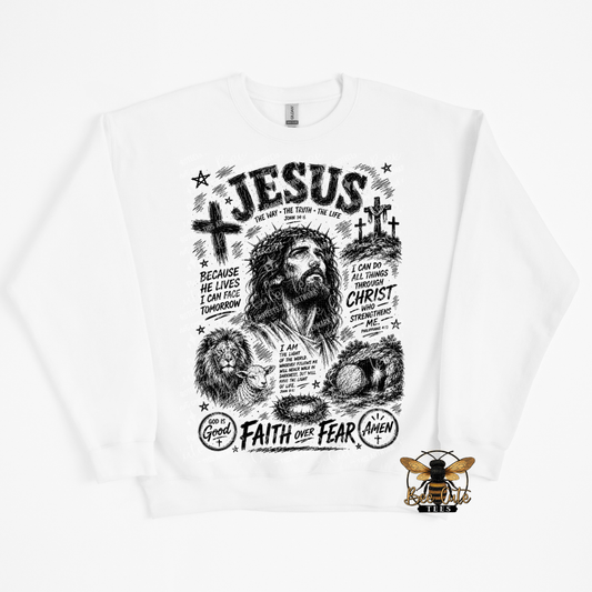 A white crewneck sweatshirt featuring a detailed black and white graphic print of Jesus Christ with religious quotes and symbols. A small bee logo for is printed in the bottom right corner of the sweatshirt.