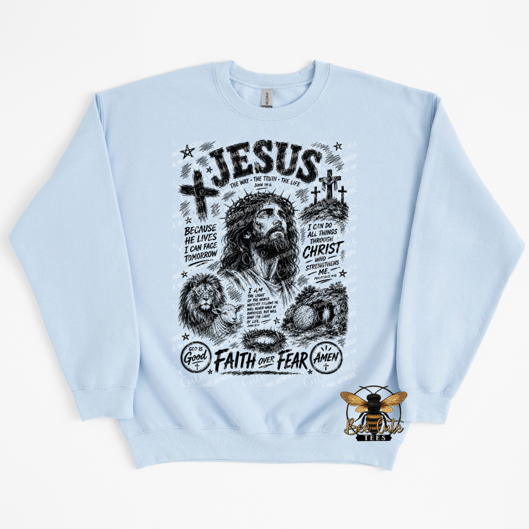 A light blue crewneck sweatshirt featuring a detailed black and white graphic print of Jesus Christ with religious text, alongside a small bee logo on the bottom right.