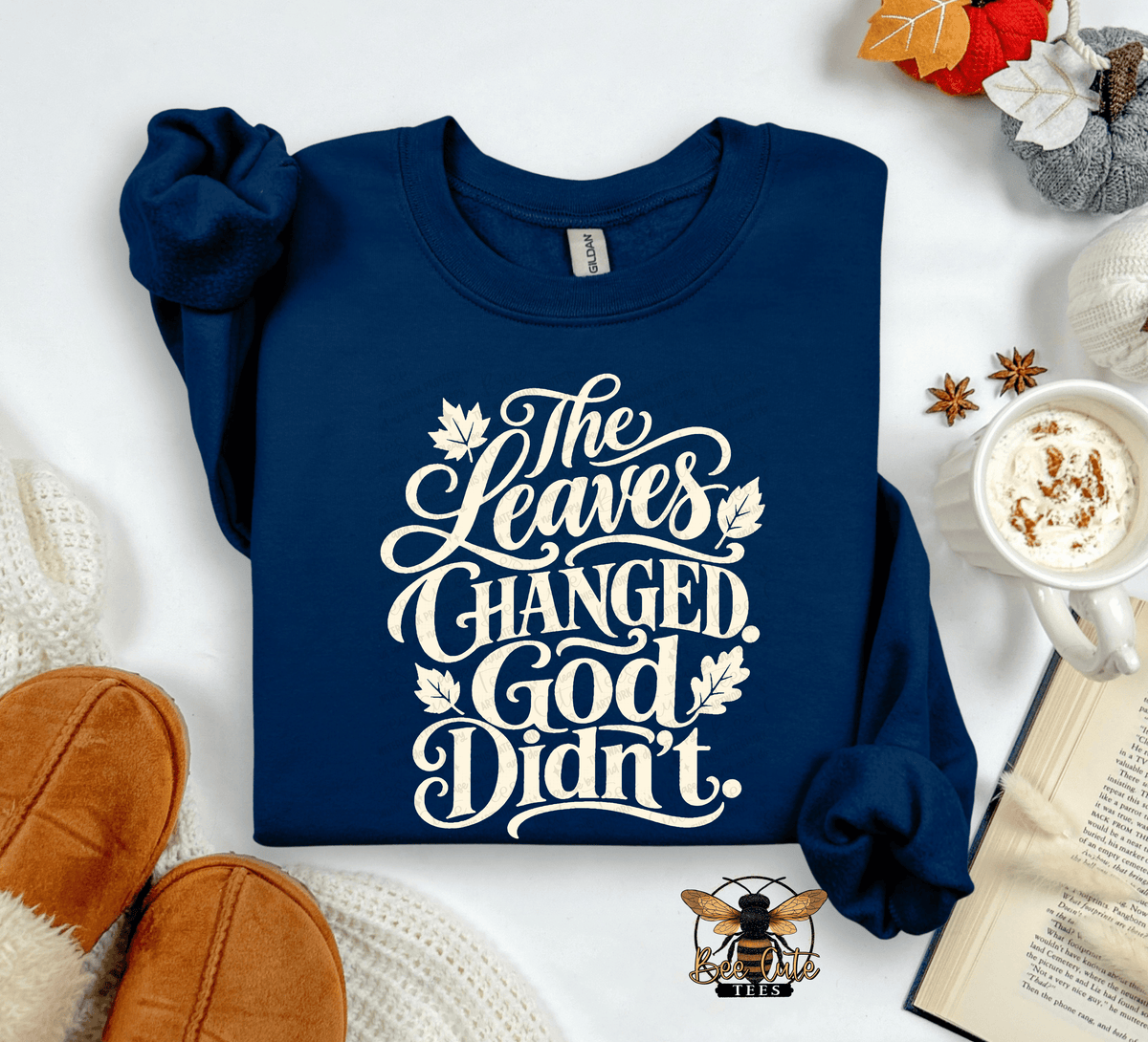A navy blue long-sleeve crewneck sweatshirt with rolled cuffs, featuring the white text 'The Leaves Changed. God Didn't.