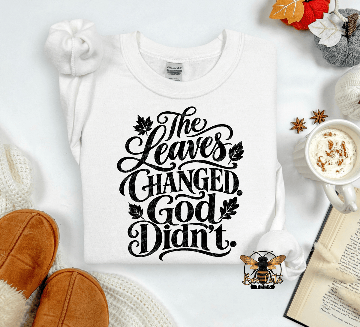 A white long-sleeve t-shirt with black cursive text reading 'The Leaves Changed. God Didn't.
