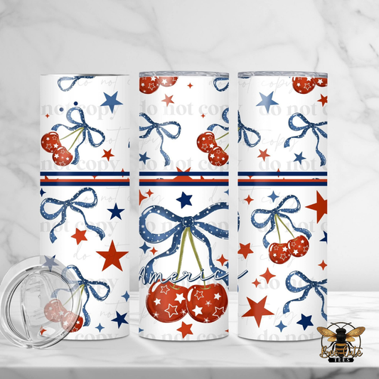 Three tumblers with red, white, and blue designs featuring stars, cherries, and bows on a white background.