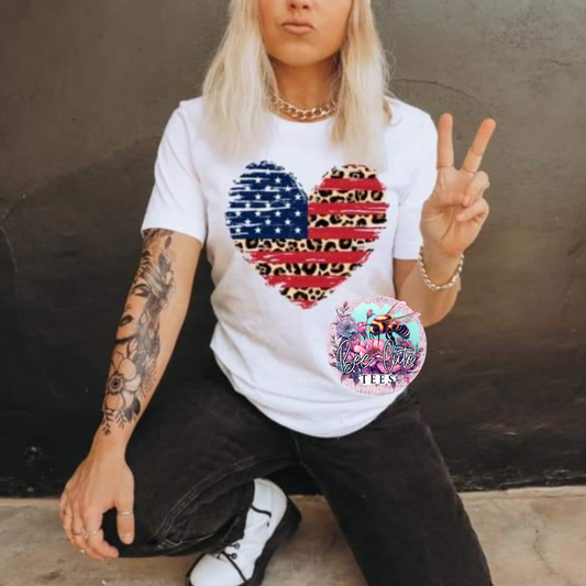 A person wearing a white t-shirt with a patriotic design, posing for the camera.