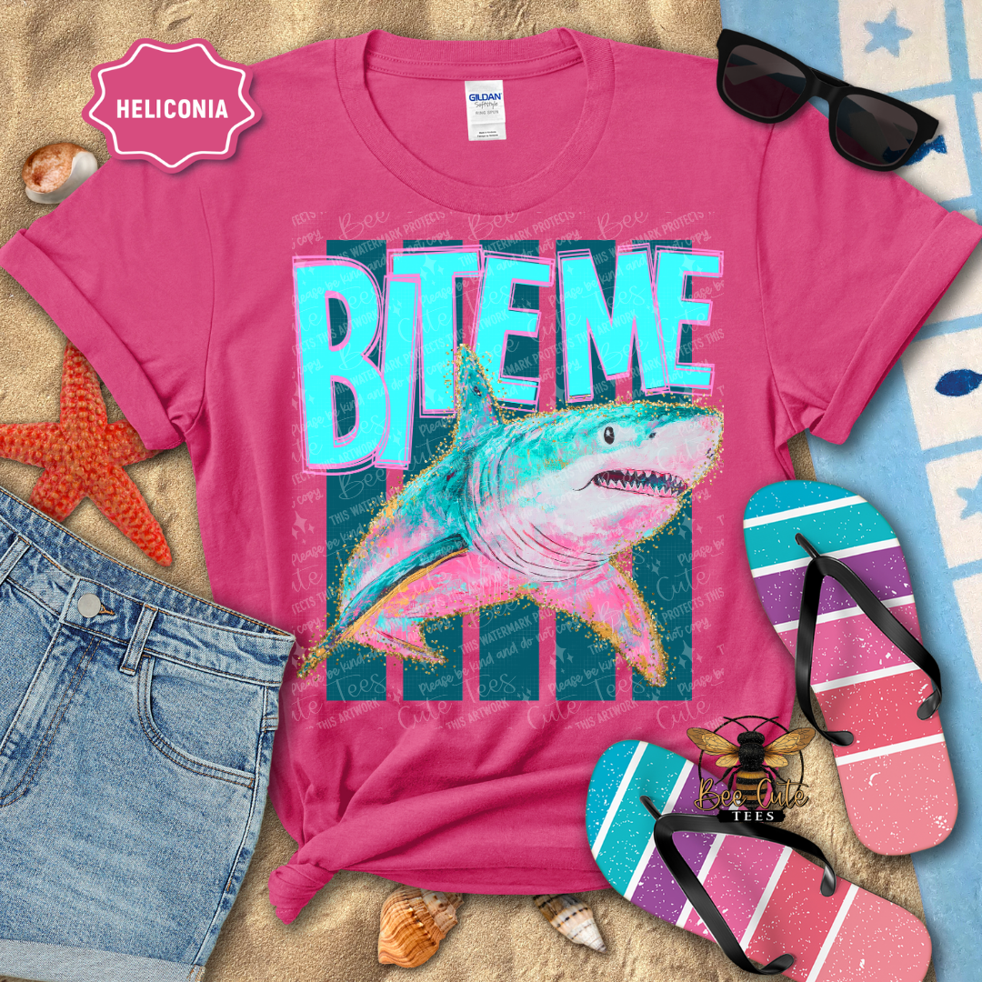Pink t-shirt with shark graphic and 'BITEME' text on a beach-themed background