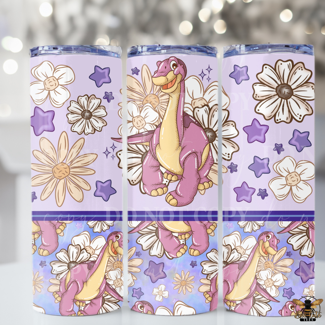 Three purple tumblers with cartoon dinosaur and floral design on a blurred light background