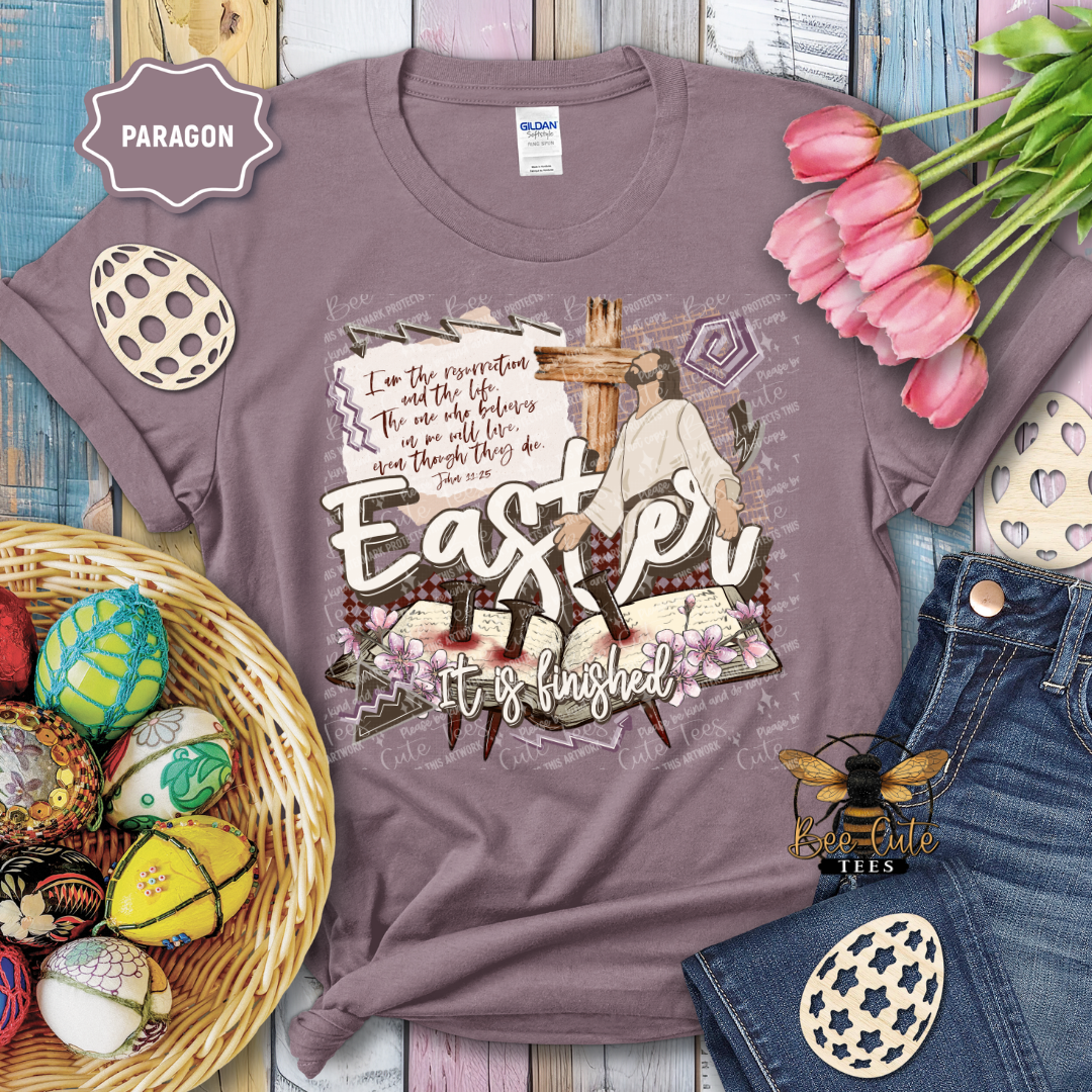 Purple t-shirt with Easter design featuring a cross and text, surrounded by Easter decorations.