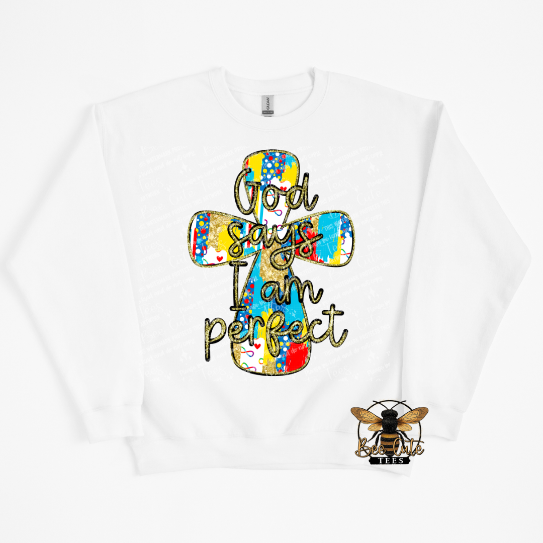 White sweatshirt with a colorful cross design and text 'God says I am perfect' on a white background.