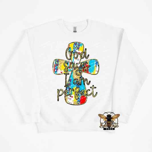 White sweatshirt with a colorful cross design and text 'God says I am perfect' on a white background.