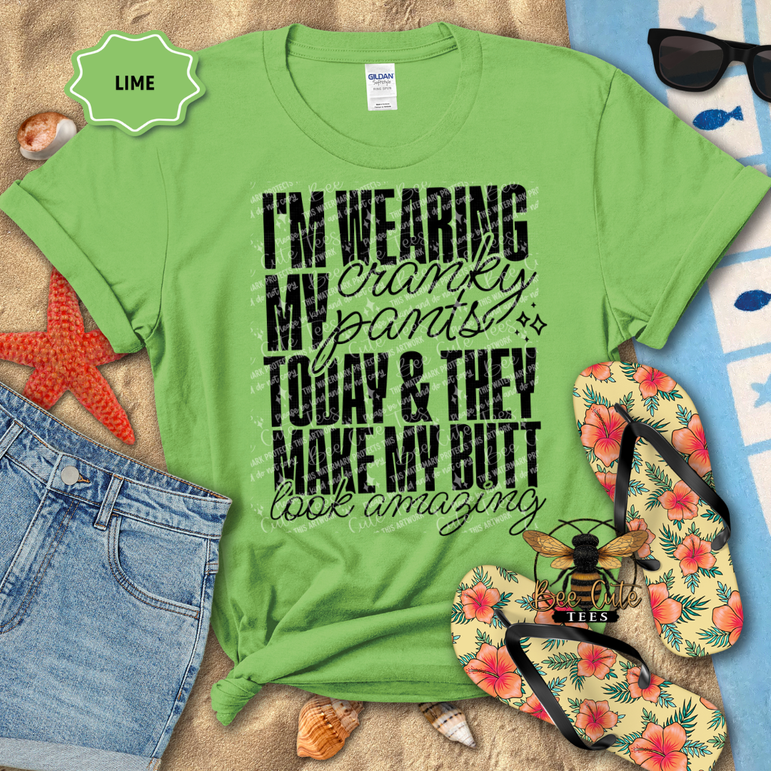 Green t-shirt with humorous text design on a beach-themed background with flip-flops and sunglasses.
