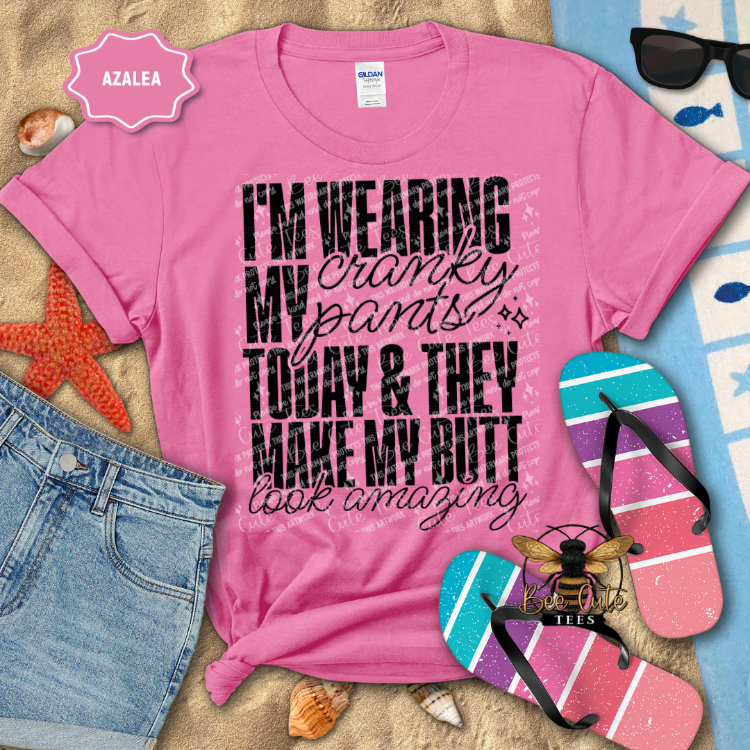 Pink t-shirt with humorous text design on a beach-themed background