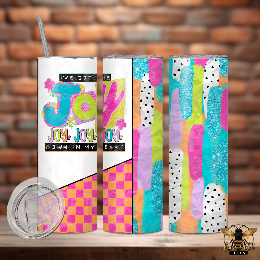 Set of colorful tumblers with abstract designs and text on a wooden surface with a brick wall background.