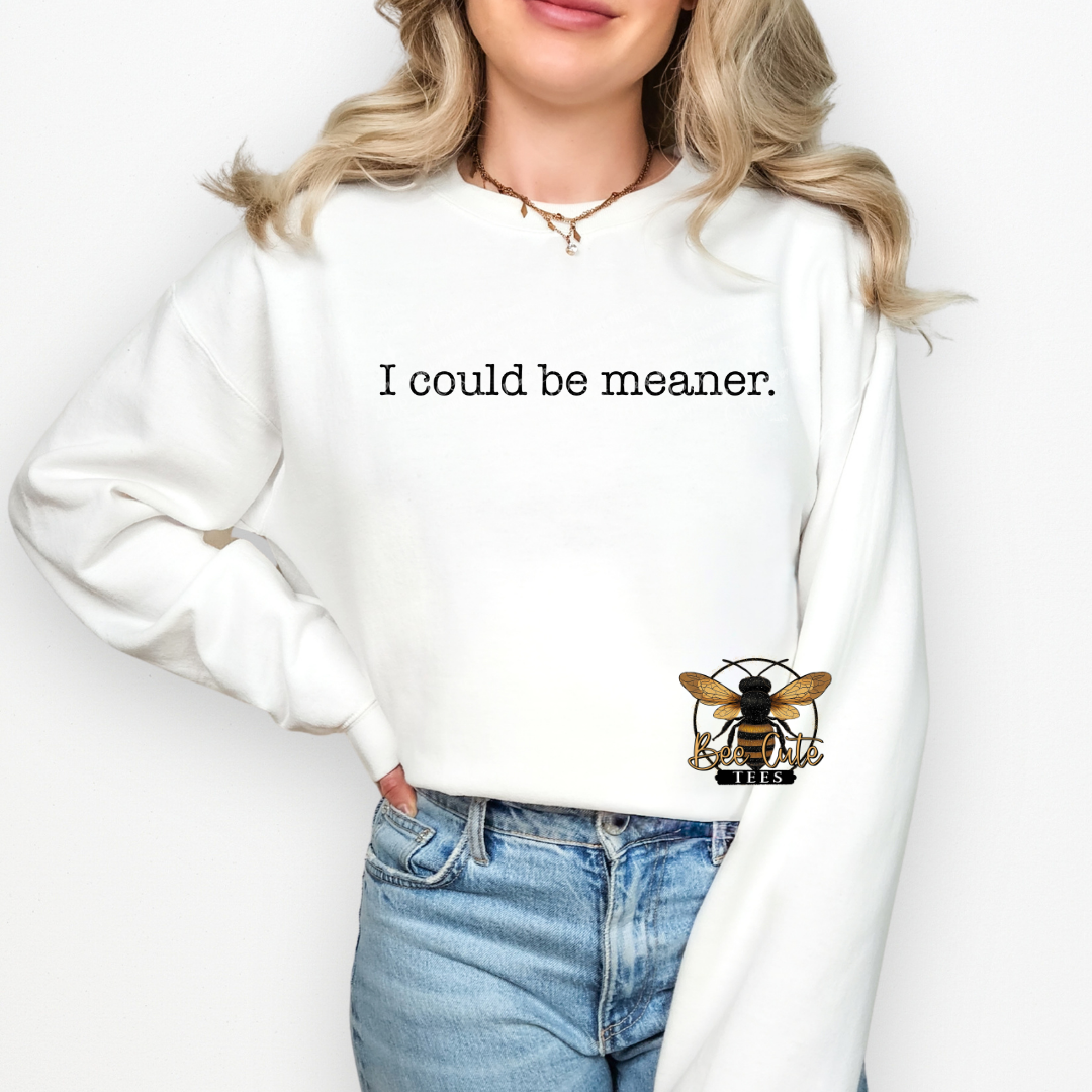 Person wearing a white sweatshirt with a bee logo and text on a plain background