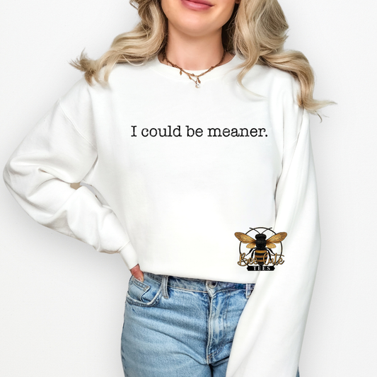 Person wearing a white sweatshirt with a bee logo and text on a plain background