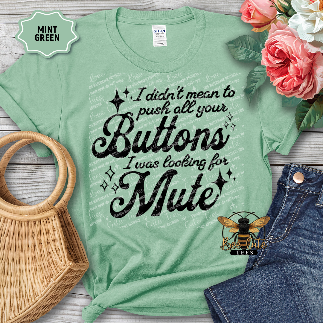 Mint green t-shirt with humorous text design, placed on a wooden surface with flowers and accessories.